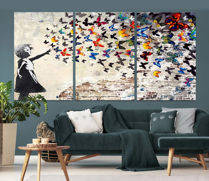 The Banksy Graffiti Wall Art Canvas Print, entitled 'Girl Releasing Vibrant Butterflies,' is a three-panel piece that is ready to hang.