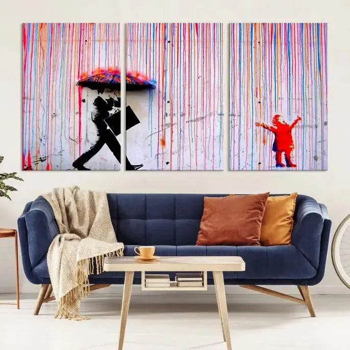 Introducing the Banksy Street Art Wall Art Canvas Print, a captivating piece featuring modern art of a man with an umbrella while a child reaches up through vibrant drips. Its premium canvas and gallery-quality finish make it an eye-catching addition to any space.