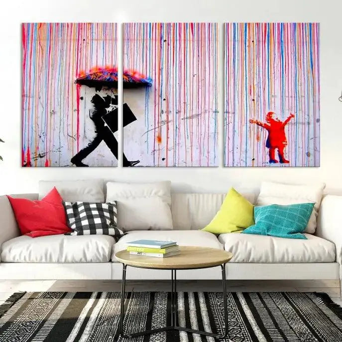 Introducing the Banksy Street Art Wall Art Canvas Print, a captivating piece featuring modern art of a man with an umbrella while a child reaches up through vibrant drips. Its premium canvas and gallery-quality finish make it an eye-catching addition to any space.