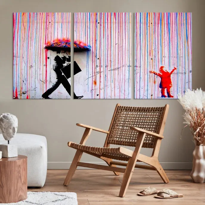 Introducing the Banksy Street Art Wall Art Canvas Print, a captivating piece featuring modern art of a man with an umbrella while a child reaches up through vibrant drips. Its premium canvas and gallery-quality finish make it an eye-catching addition to any space.