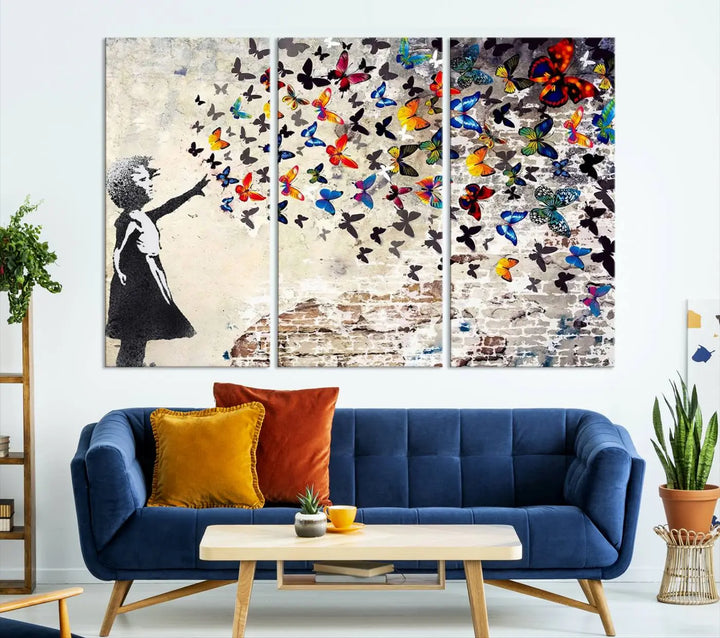 The Banksy Style Wall Art Print, featuring the Banksy Girl with Butterflies design, is a beautiful framed ready-to-hang triptych canvas that depicts a child releasing vibrant butterflies. It creates an enchanting tribute reminiscent of a Banksy scene.