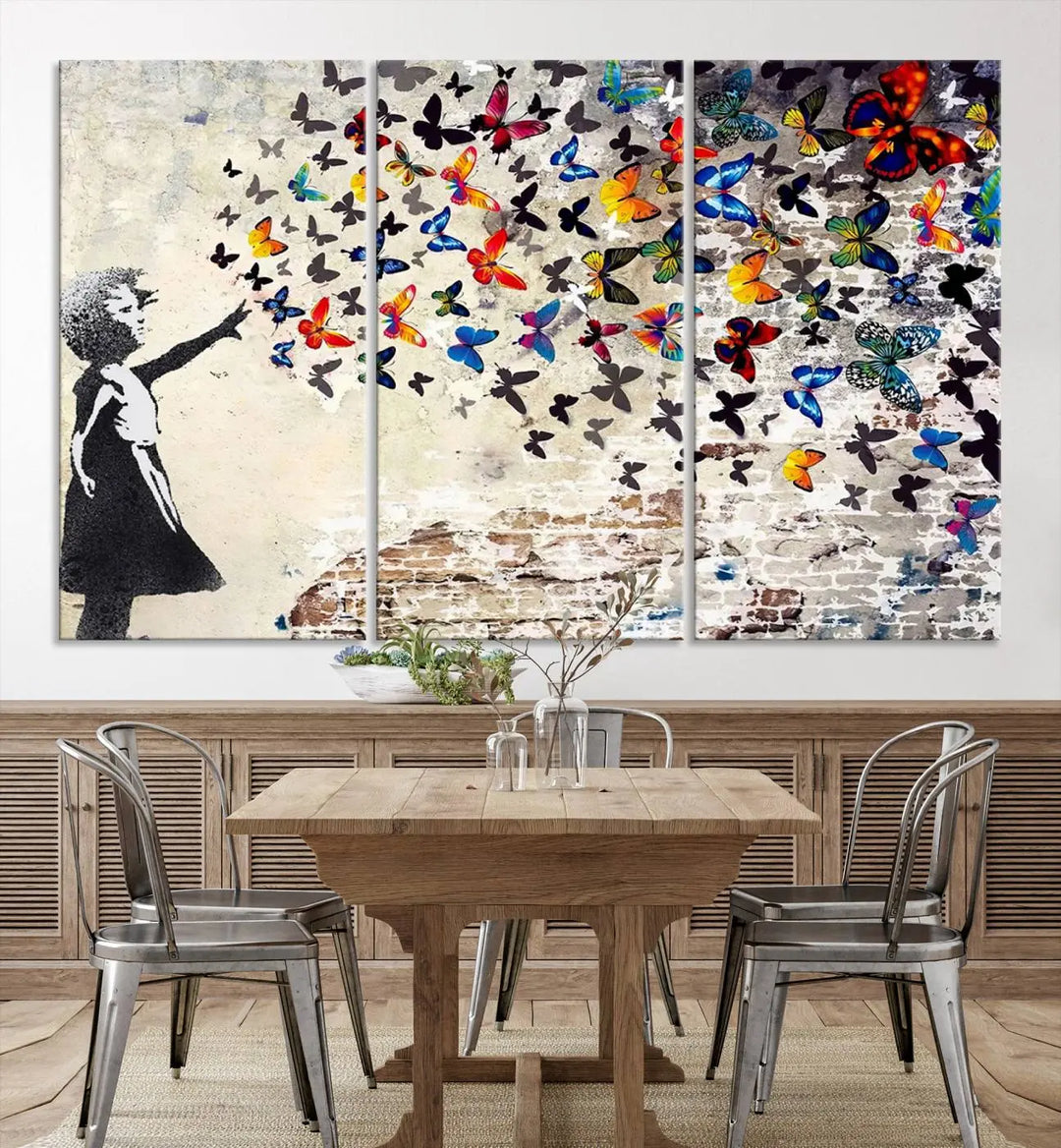 The Banksy Style Wall Art Print, featuring the Banksy Girl with Butterflies design, is a beautiful framed ready-to-hang triptych canvas that depicts a child releasing vibrant butterflies. It creates an enchanting tribute reminiscent of a Banksy scene.