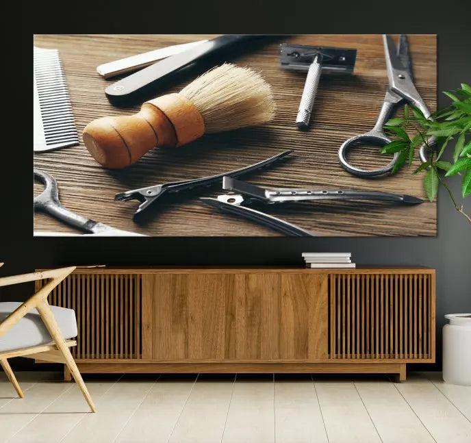 The Barber Tools Wall Art Canvas Print elegantly showcases the barbering profession with illustrations of tools like scissors, a brush, and a comb.