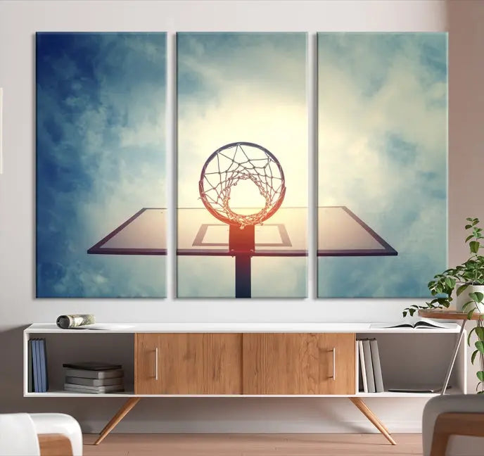 A triptych wall art titled "Basketball Hoop Wall Art Canvas Print | Sport Wall Art" features a basketball hoop set against a cloudy sky. It is printed on museum-quality canvas with gallery wrapping.