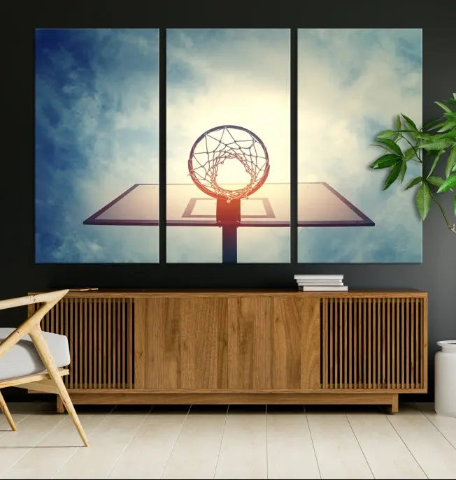 A triptych wall art titled "Basketball Hoop Wall Art Canvas Print | Sport Wall Art" features a basketball hoop set against a cloudy sky. It is printed on museum-quality canvas with gallery wrapping.