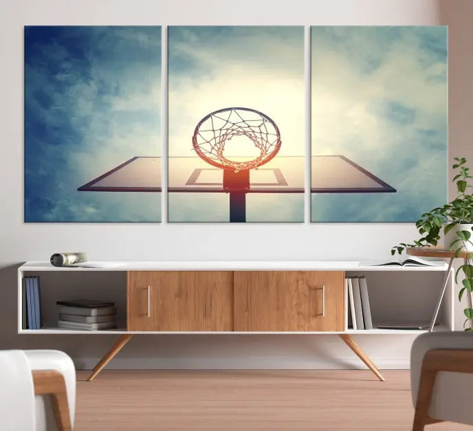 A triptych wall art titled "Basketball Hoop Wall Art Canvas Print | Sport Wall Art" features a basketball hoop set against a cloudy sky. It is printed on museum-quality canvas with gallery wrapping.