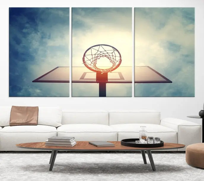 A triptych wall art titled "Basketball Hoop Wall Art Canvas Print | Sport Wall Art" features a basketball hoop set against a cloudy sky. It is printed on museum-quality canvas with gallery wrapping.