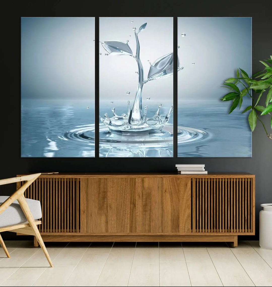 The living room features a three-panel wall art titled "Bathroom Wall Art Blue Leaf Canvas," showcasing water splash shapes that form plant-like designs on gallery-wrapped, museum-quality canvas.