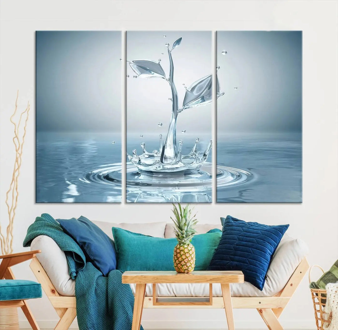 The living room features a three-panel wall art titled "Bathroom Wall Art Blue Leaf Canvas," showcasing water splash shapes that form plant-like designs on gallery-wrapped, museum-quality canvas.