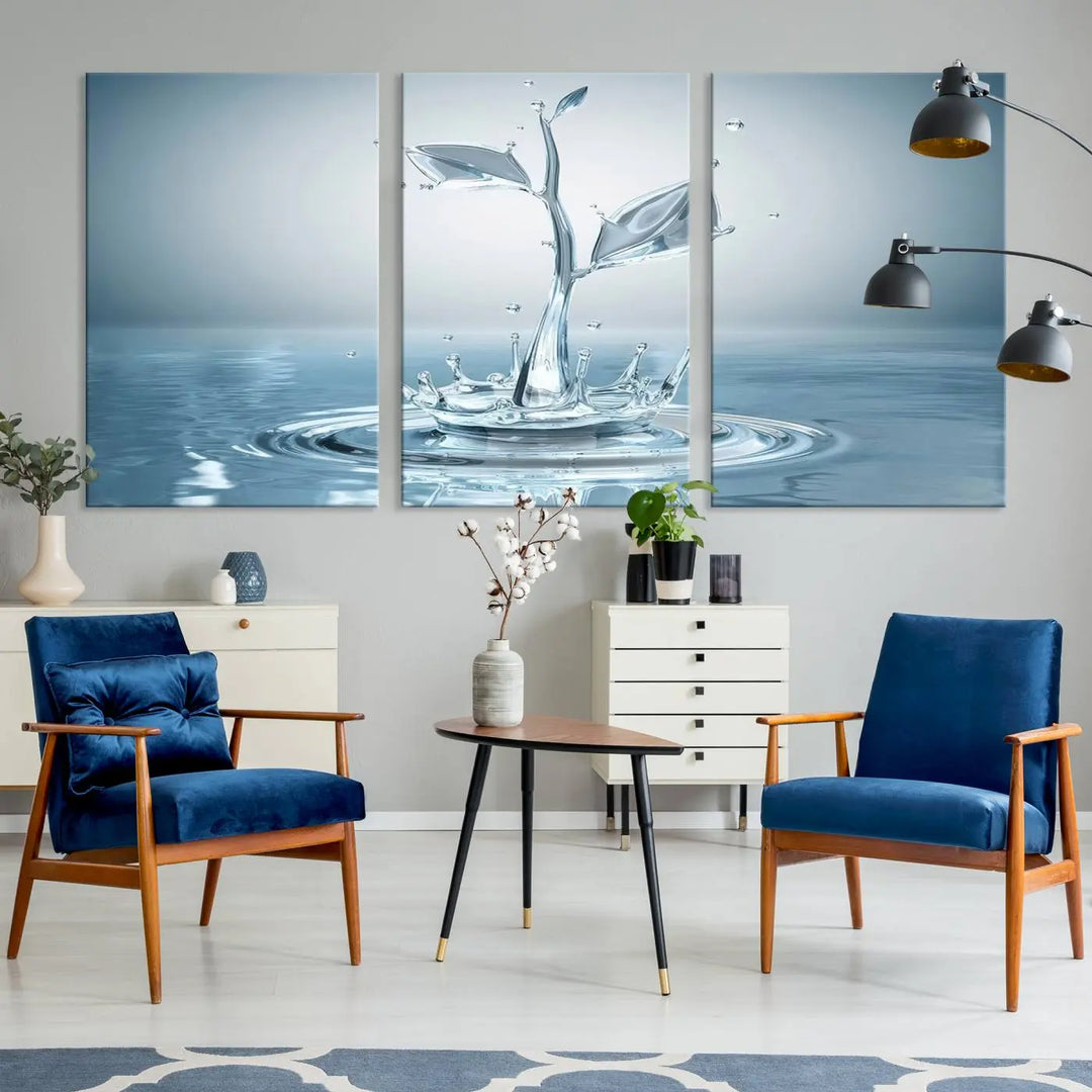 The living room features a three-panel wall art titled "Bathroom Wall Art Blue Leaf Canvas," showcasing water splash shapes that form plant-like designs on gallery-wrapped, museum-quality canvas.