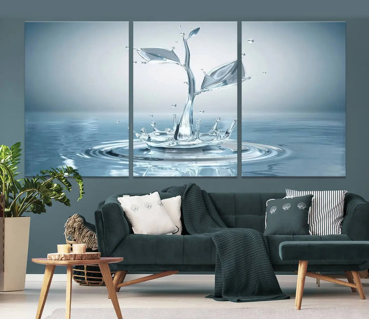 The living room features a three-panel wall art titled "Bathroom Wall Art Blue Leaf Canvas," showcasing water splash shapes that form plant-like designs on gallery-wrapped, museum-quality canvas.