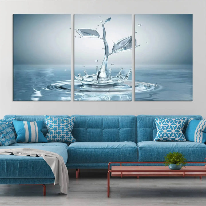 The living room features a three-panel wall art titled "Bathroom Wall Art Blue Leaf Canvas," showcasing water splash shapes that form plant-like designs on gallery-wrapped, museum-quality canvas.