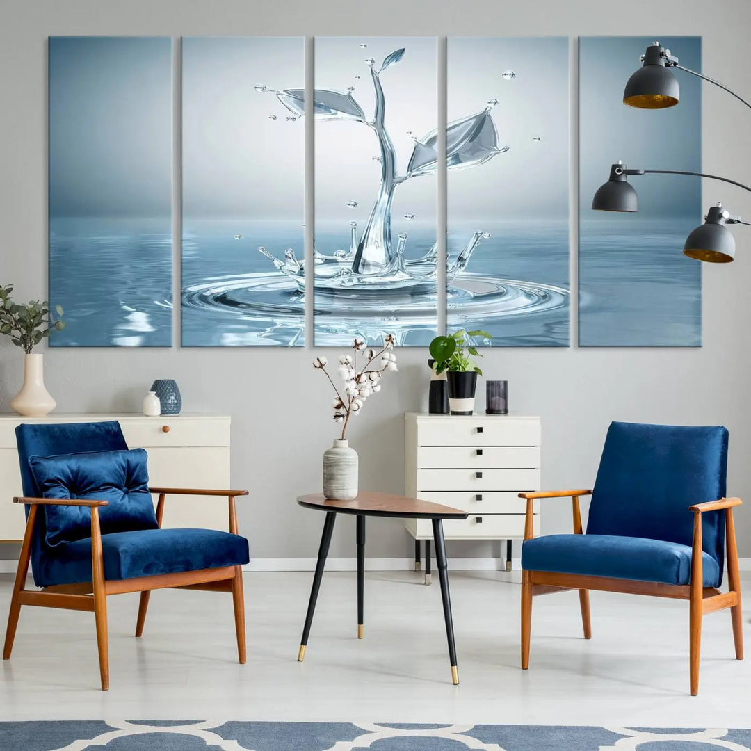 The living room features a three-panel wall art titled "Bathroom Wall Art Blue Leaf Canvas," showcasing water splash shapes that form plant-like designs on gallery-wrapped, museum-quality canvas.