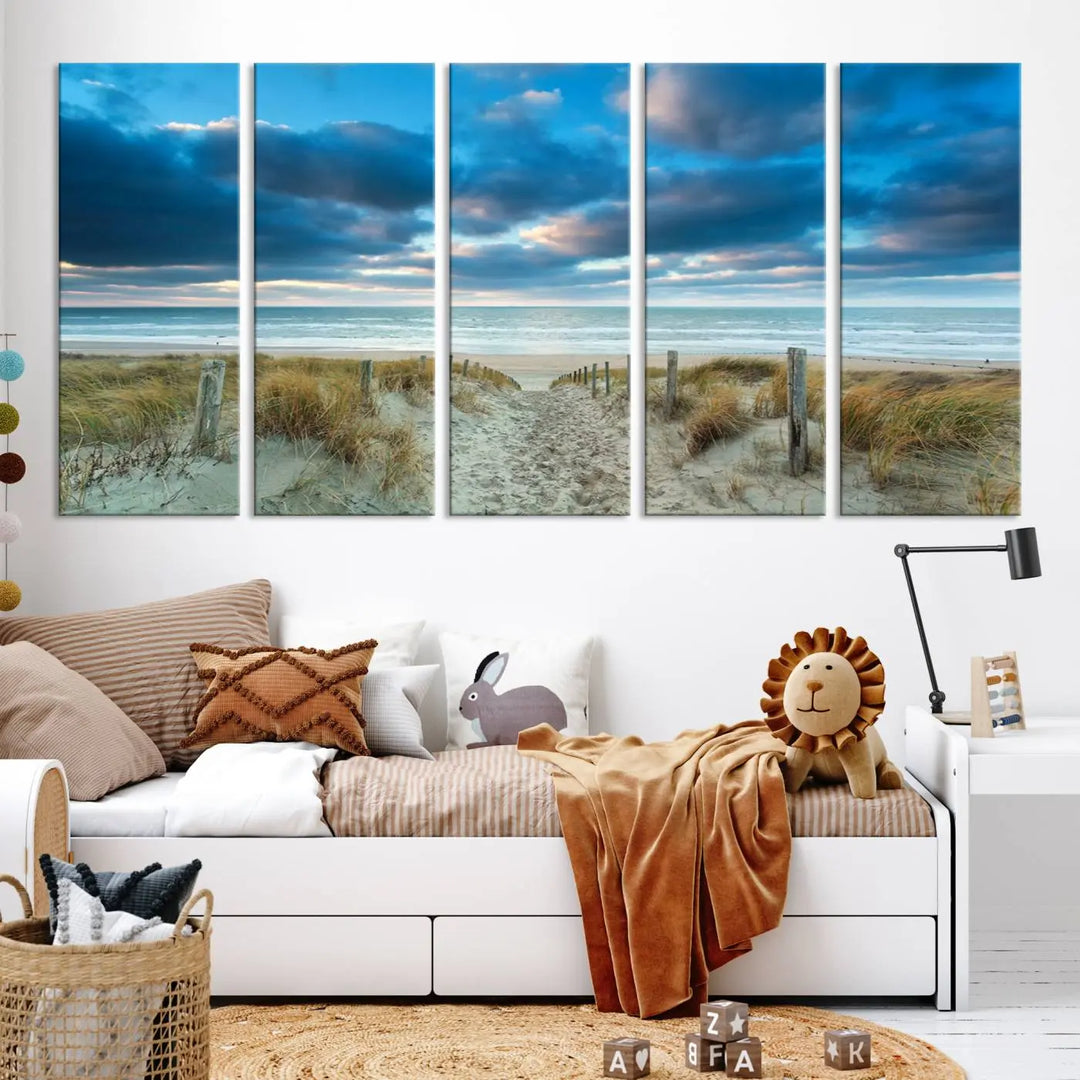 The "Beach Ocean Sun Sand Wall Art Canvas Print" is a triptych showcasing a beach path with grass leading to the ocean under a dramatic cloudy sky. This museum-quality canvas includes a UV-protective coating for longevity and vibrancy, and it comes ready to hang for effortless elegance.