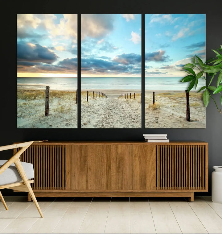 The Beach Ocean Sunset Sand Wall Art Canvas Print, renowned for its museum-quality and UV-protective coating, is elegantly displayed on a dark wall.