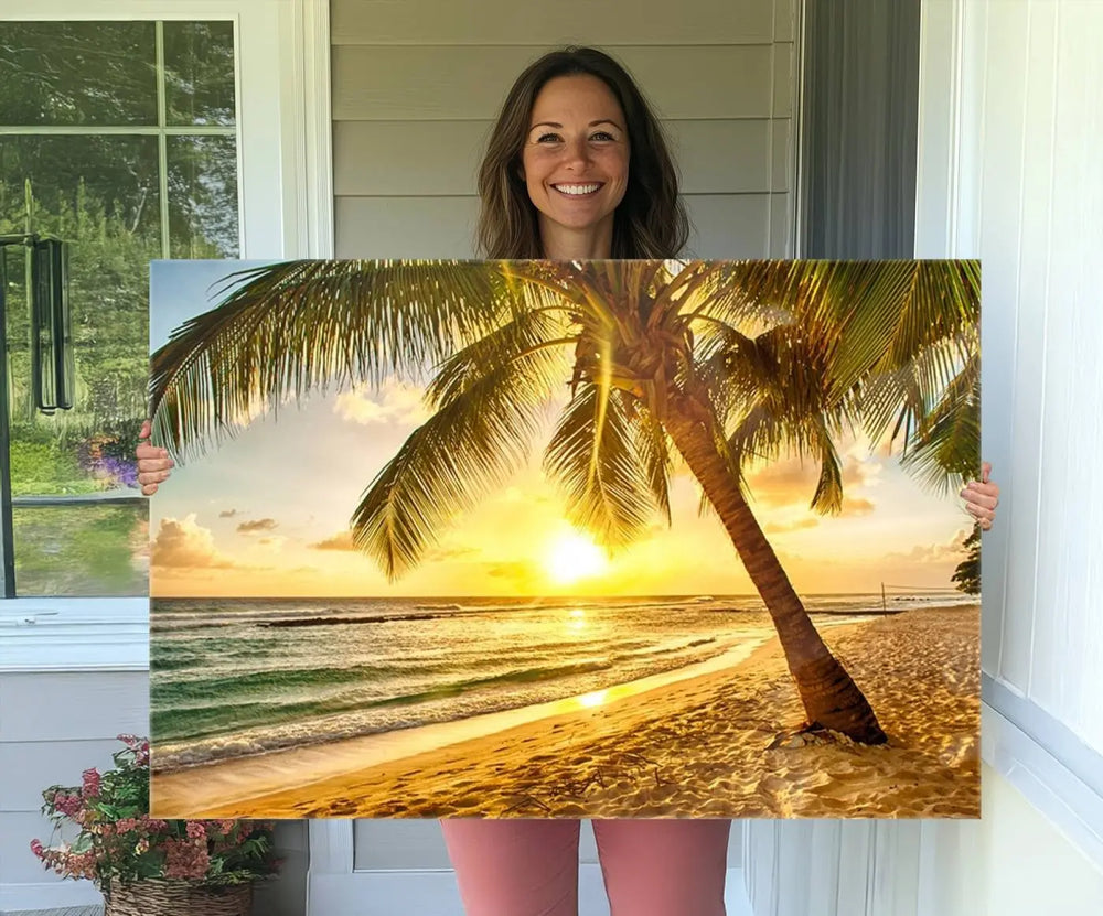 Beach Sunset Canvas Wall Art with a palm tree embellishes a living room with modern decor.