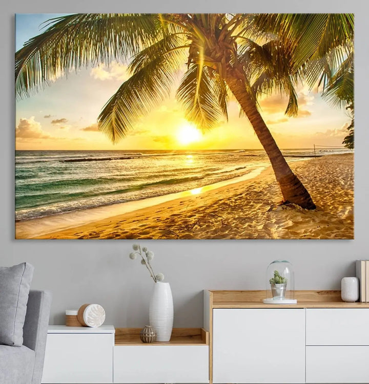 Beach Sunset Canvas Wall Art with a palm tree embellishes a living room with modern decor.