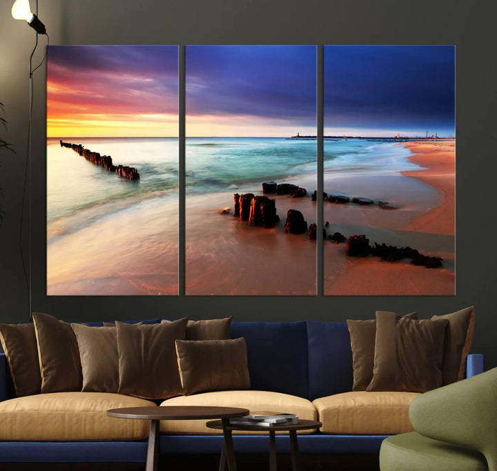 The gray wall in this living room is enhanced by a large beach triptych canvas wall art titled "Beach Sunset and Ocean Waves Canvas Wall Art, Set of 3, Seaside Serenity Coastal Decor," which captures the essence of a serene ocean scene.