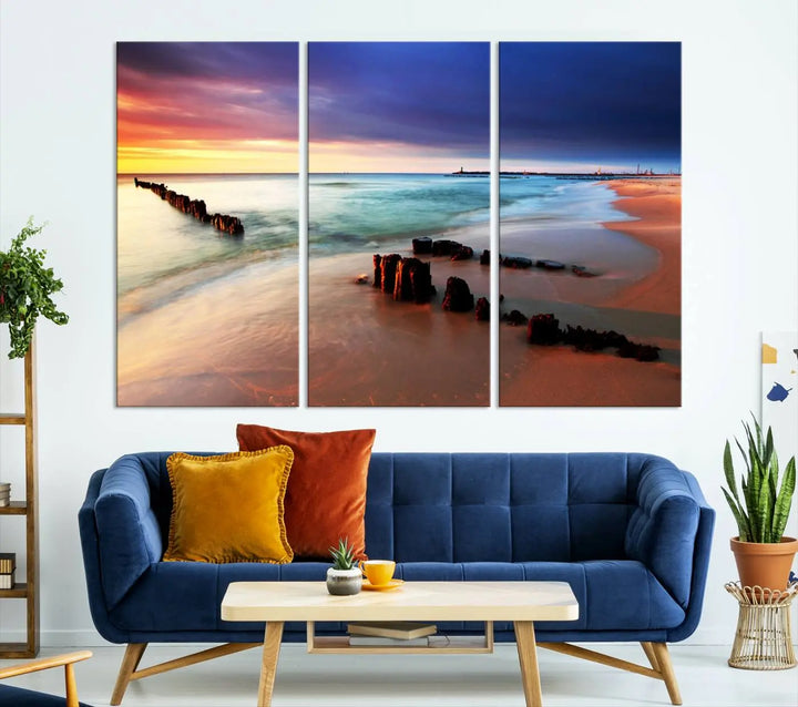 The gray wall in this living room is enhanced by a large beach triptych canvas wall art titled "Beach Sunset and Ocean Waves Canvas Wall Art, Set of 3, Seaside Serenity Coastal Decor," which captures the essence of a serene ocean scene.