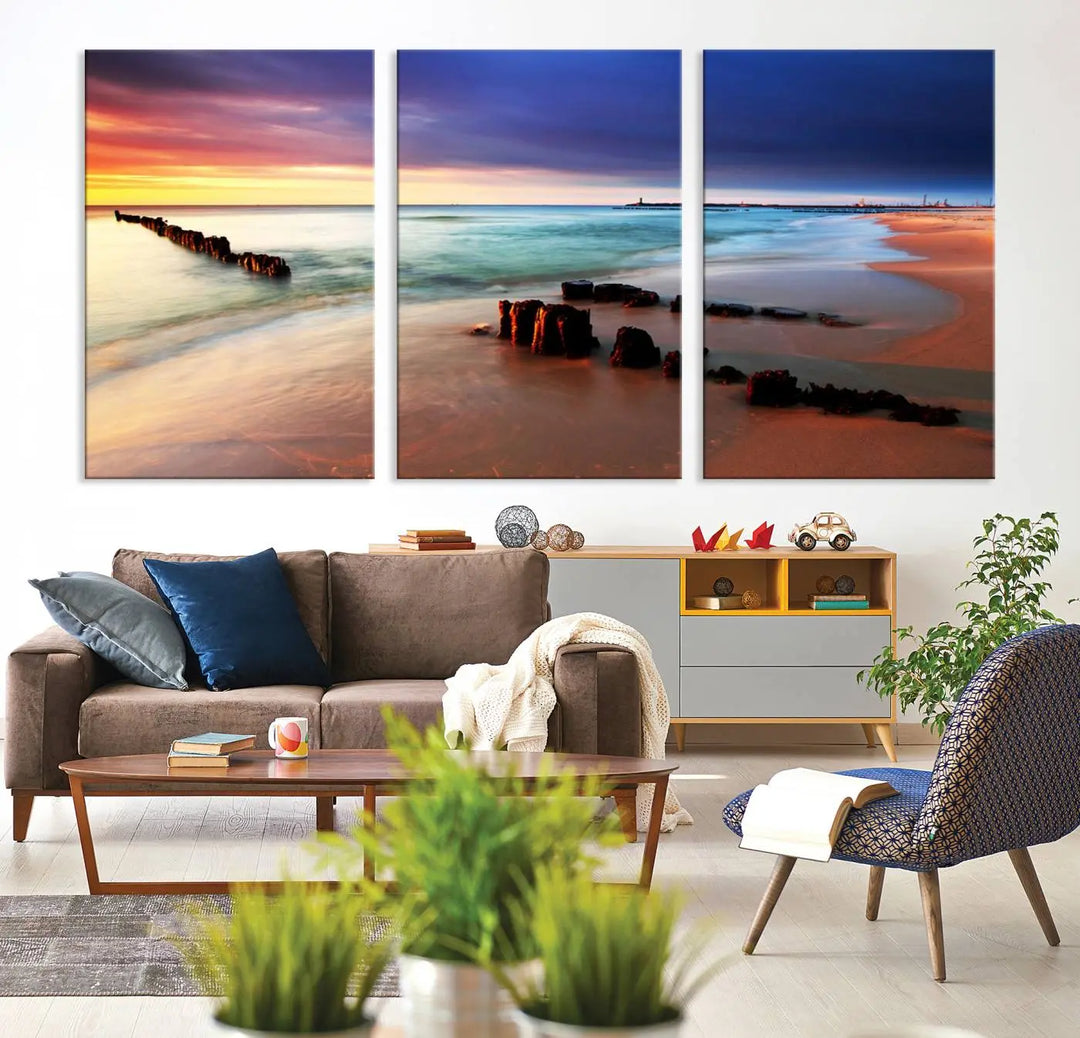 The gray wall in this living room is enhanced by a large beach triptych canvas wall art titled "Beach Sunset and Ocean Waves Canvas Wall Art, Set of 3, Seaside Serenity Coastal Decor," which captures the essence of a serene ocean scene.