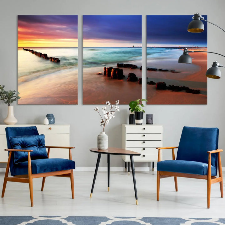 The gray wall in this living room is enhanced by a large beach triptych canvas wall art titled "Beach Sunset and Ocean Waves Canvas Wall Art, Set of 3, Seaside Serenity Coastal Decor," which captures the essence of a serene ocean scene.