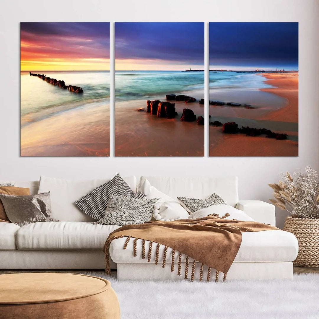 The gray wall in this living room is enhanced by a large beach triptych canvas wall art titled "Beach Sunset and Ocean Waves Canvas Wall Art, Set of 3, Seaside Serenity Coastal Decor," which captures the essence of a serene ocean scene.