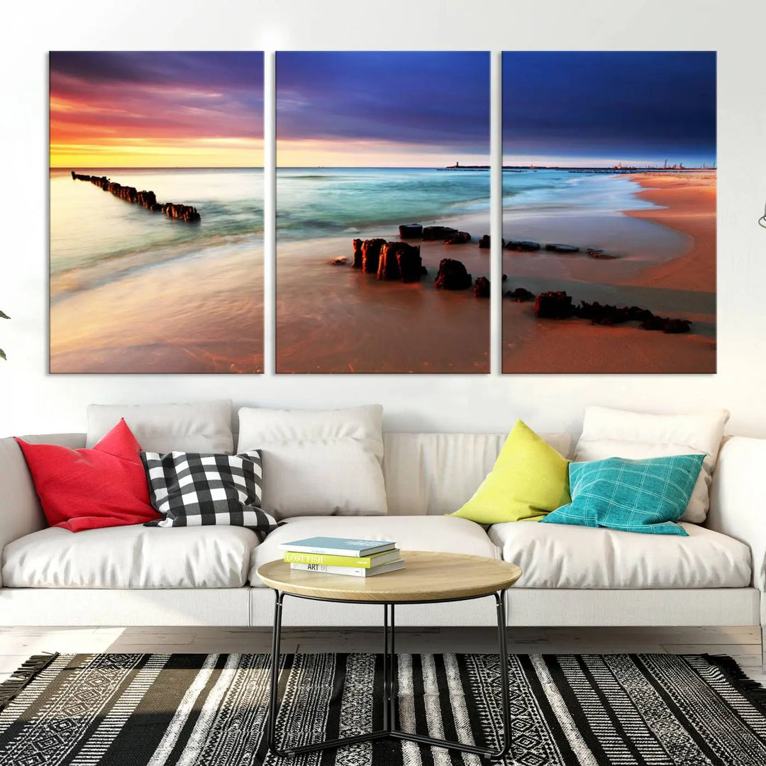 The gray wall in this living room is enhanced by a large beach triptych canvas wall art titled "Beach Sunset and Ocean Waves Canvas Wall Art, Set of 3, Seaside Serenity Coastal Decor," which captures the essence of a serene ocean scene.