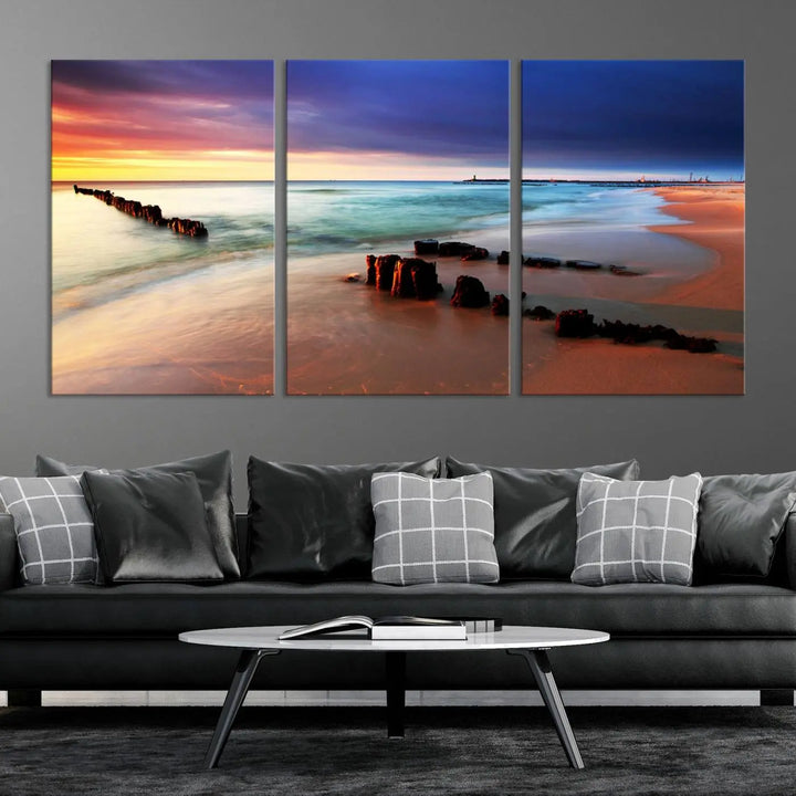 The gray wall in this living room is enhanced by a large beach triptych canvas wall art titled "Beach Sunset and Ocean Waves Canvas Wall Art, Set of 3, Seaside Serenity Coastal Decor," which captures the essence of a serene ocean scene.