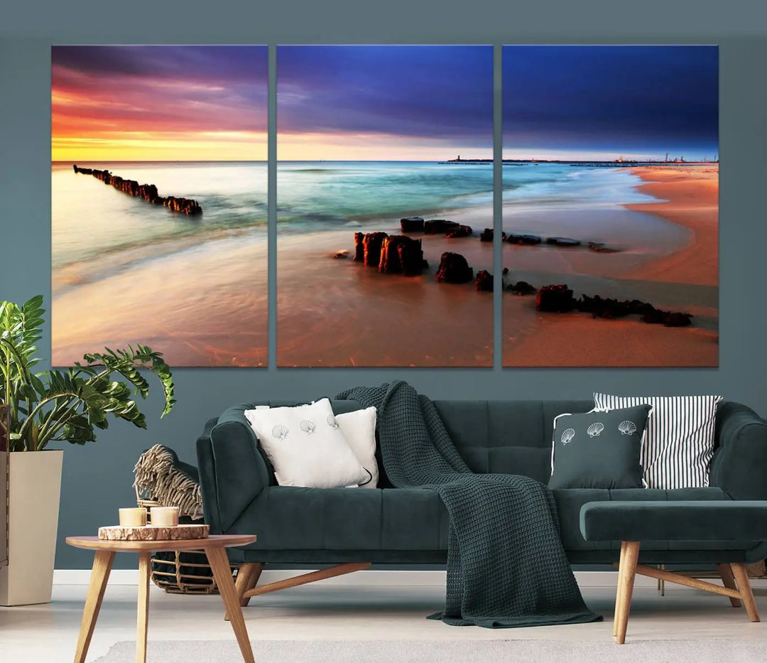 The gray wall in this living room is enhanced by a large beach triptych canvas wall art titled "Beach Sunset and Ocean Waves Canvas Wall Art, Set of 3, Seaside Serenity Coastal Decor," which captures the essence of a serene ocean scene.