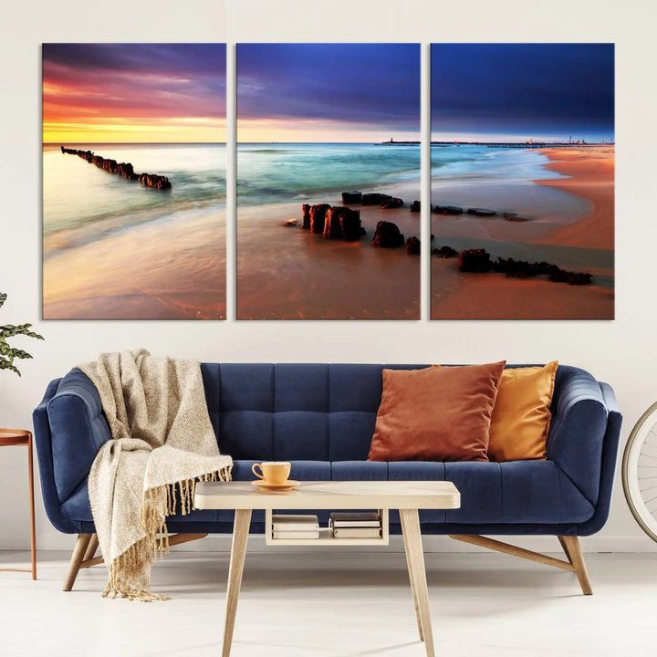 The gray wall in this living room is enhanced by a large beach triptych canvas wall art titled "Beach Sunset and Ocean Waves Canvas Wall Art, Set of 3, Seaside Serenity Coastal Decor," which captures the essence of a serene ocean scene.