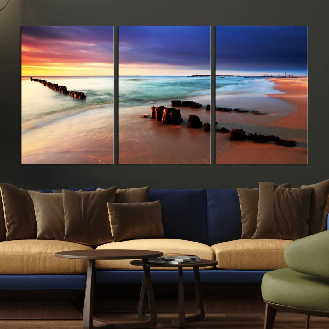 The gray wall in this living room is enhanced by a large beach triptych canvas wall art titled "Beach Sunset and Ocean Waves Canvas Wall Art, Set of 3, Seaside Serenity Coastal Decor," which captures the essence of a serene ocean scene.