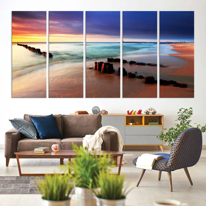 The gray wall in this living room is enhanced by a large beach triptych canvas wall art titled "Beach Sunset and Ocean Waves Canvas Wall Art, Set of 3, Seaside Serenity Coastal Decor," which captures the essence of a serene ocean scene.