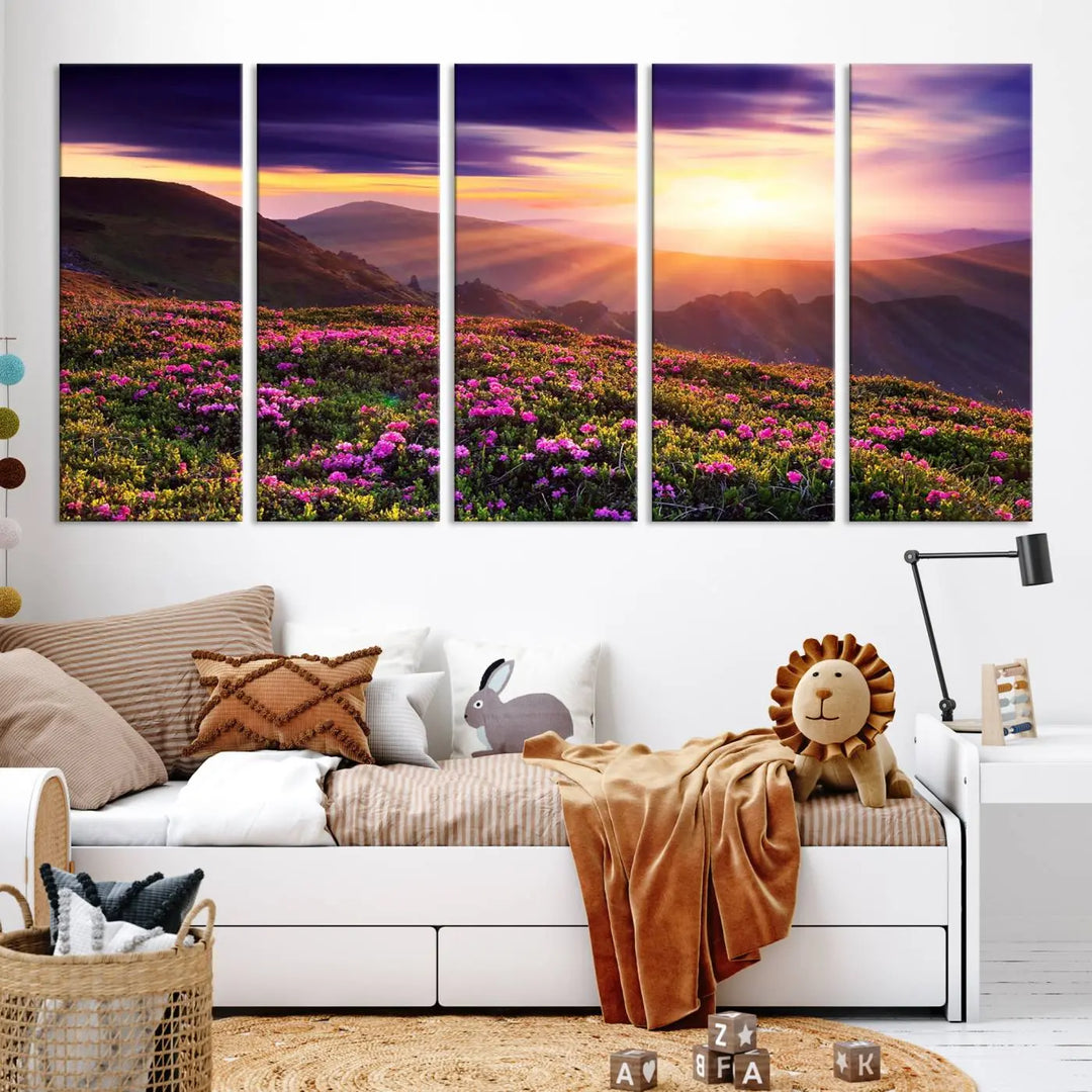 A living room showcases the Beautiful Mountain Sunset Landscape with Purple Flowers Canvas Wall Art Print, featuring a triptych of a vibrant sunset over mountains and blooming flowers, vividly rendered on museum-quality canvas with UV-protective coating.