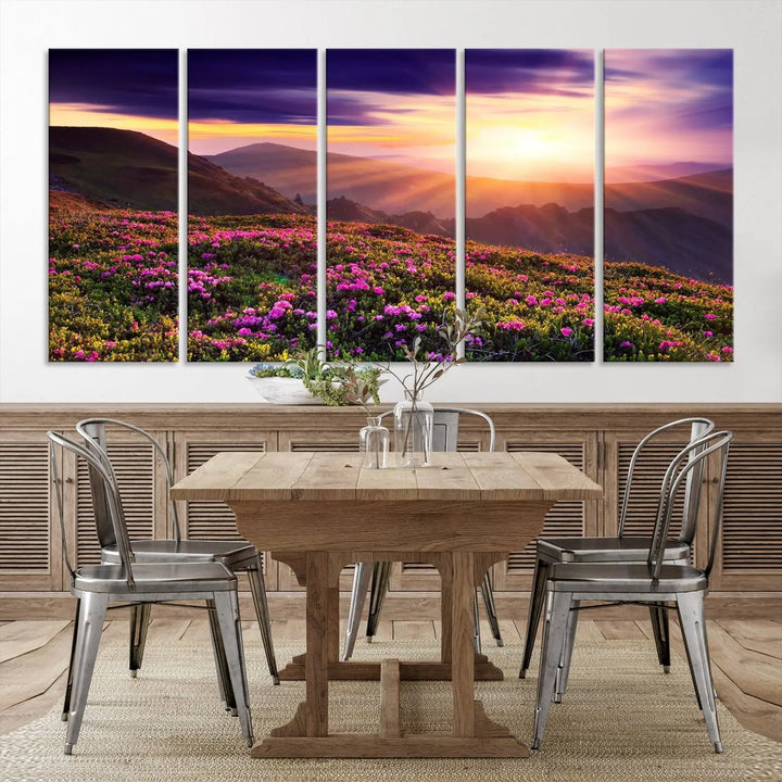 A living room showcases the Beautiful Mountain Sunset Landscape with Purple Flowers Canvas Wall Art Print, featuring a triptych of a vibrant sunset over mountains and blooming flowers, vividly rendered on museum-quality canvas with UV-protective coating.