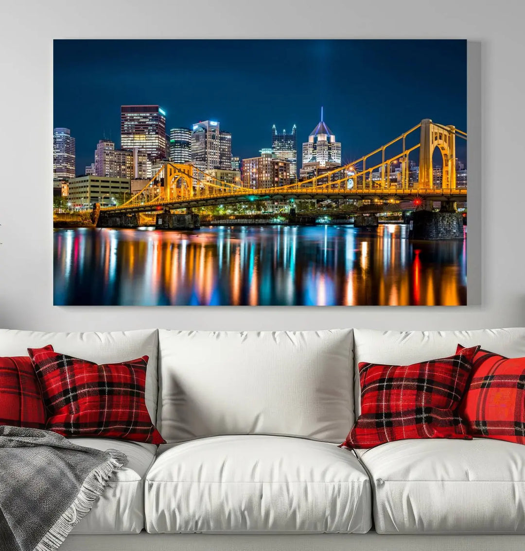 A cityscape at night showcases the illuminated beauty of Pittsburgh, with its bridge and skyscrapers casting glowing reflections on the river, all beautifully captured on this museum-quality canvas titled "Beautiful Pittsburgh Skyline Wall Art.