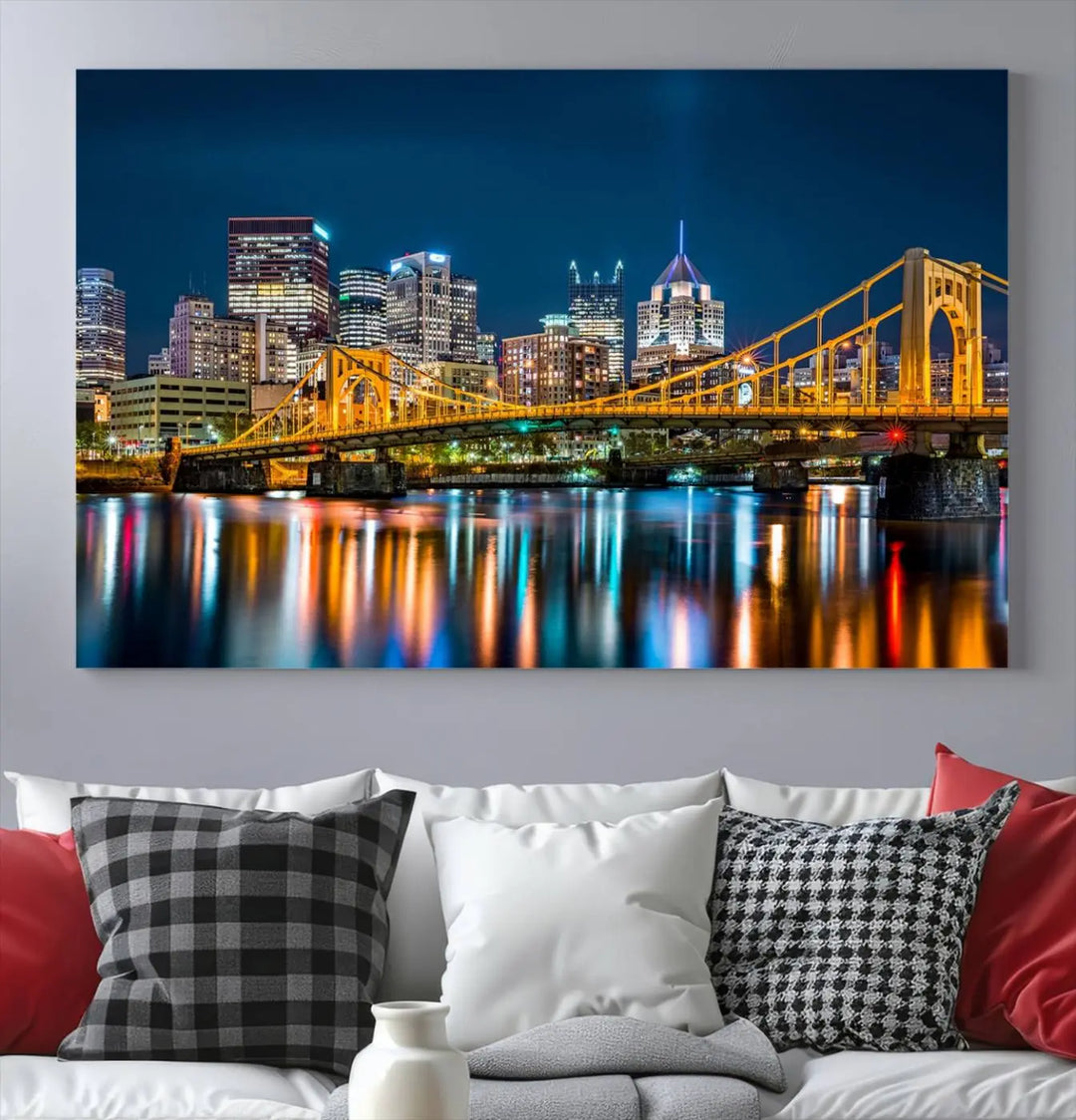 A cityscape at night showcases the illuminated beauty of Pittsburgh, with its bridge and skyscrapers casting glowing reflections on the river, all beautifully captured on this museum-quality canvas titled "Beautiful Pittsburgh Skyline Wall Art.