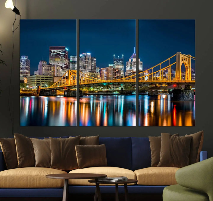 A cityscape at night showcases the illuminated beauty of Pittsburgh, with its bridge and skyscrapers casting glowing reflections on the river, all beautifully captured on this museum-quality canvas titled "Beautiful Pittsburgh Skyline Wall Art.