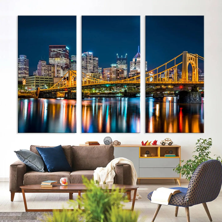 A cityscape at night showcases the illuminated beauty of Pittsburgh, with its bridge and skyscrapers casting glowing reflections on the river, all beautifully captured on this museum-quality canvas titled "Beautiful Pittsburgh Skyline Wall Art.