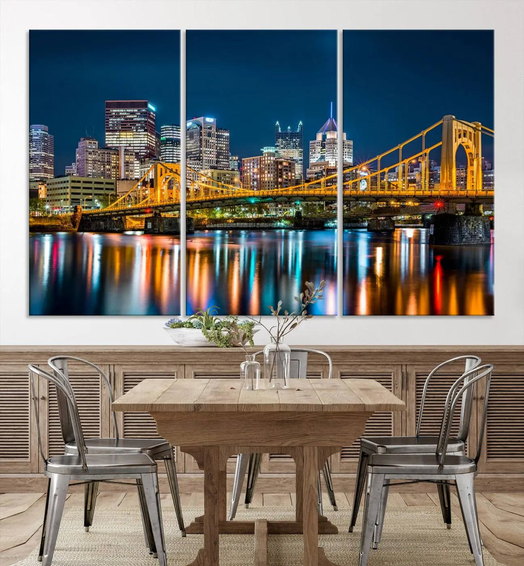 A cityscape at night showcases the illuminated beauty of Pittsburgh, with its bridge and skyscrapers casting glowing reflections on the river, all beautifully captured on this museum-quality canvas titled "Beautiful Pittsburgh Skyline Wall Art.