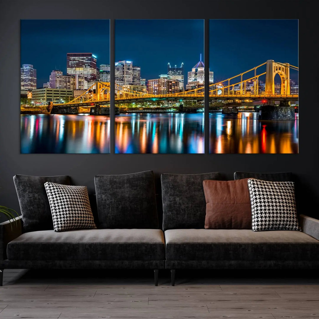 A cityscape at night showcases the illuminated beauty of Pittsburgh, with its bridge and skyscrapers casting glowing reflections on the river, all beautifully captured on this museum-quality canvas titled "Beautiful Pittsburgh Skyline Wall Art.