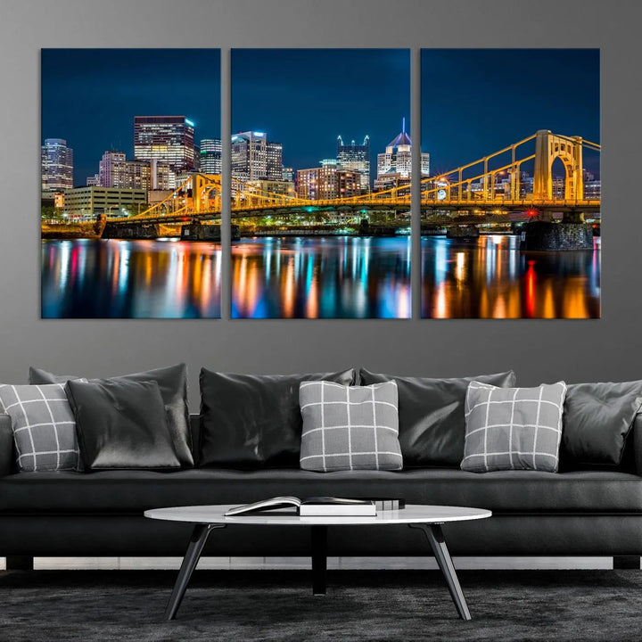 A cityscape at night showcases the illuminated beauty of Pittsburgh, with its bridge and skyscrapers casting glowing reflections on the river, all beautifully captured on this museum-quality canvas titled "Beautiful Pittsburgh Skyline Wall Art.