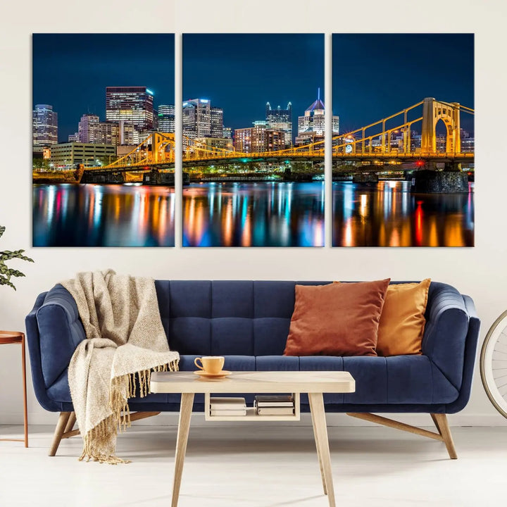 A cityscape at night showcases the illuminated beauty of Pittsburgh, with its bridge and skyscrapers casting glowing reflections on the river, all beautifully captured on this museum-quality canvas titled "Beautiful Pittsburgh Skyline Wall Art.