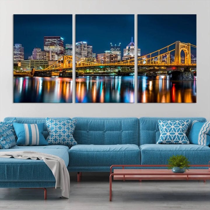 A cityscape at night showcases the illuminated beauty of Pittsburgh, with its bridge and skyscrapers casting glowing reflections on the river, all beautifully captured on this museum-quality canvas titled "Beautiful Pittsburgh Skyline Wall Art.