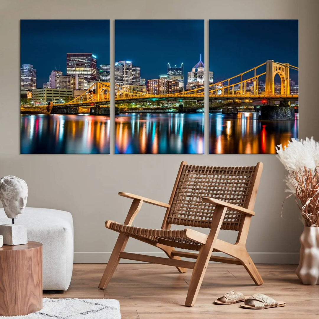 A cityscape at night showcases the illuminated beauty of Pittsburgh, with its bridge and skyscrapers casting glowing reflections on the river, all beautifully captured on this museum-quality canvas titled "Beautiful Pittsburgh Skyline Wall Art.