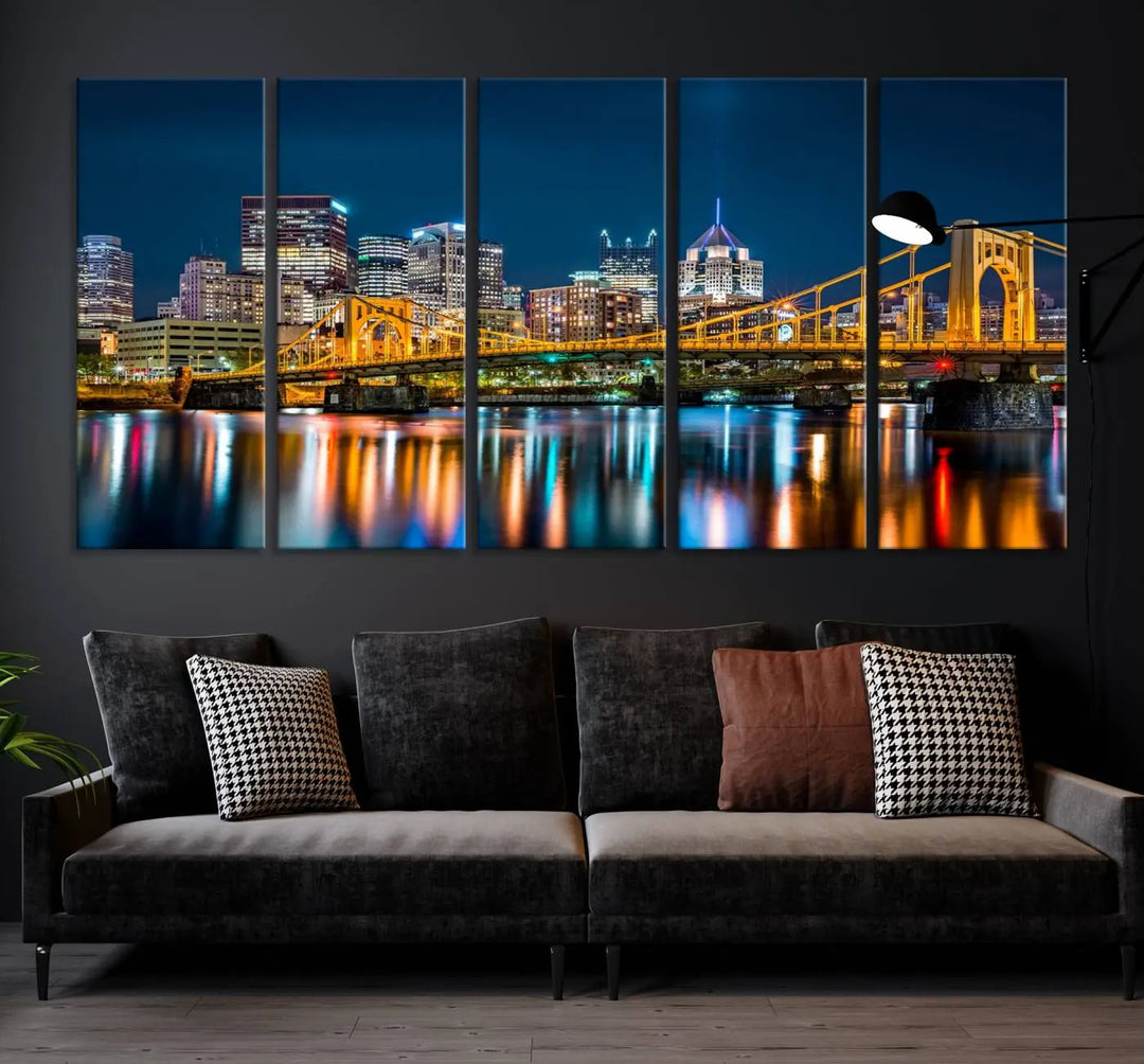 A cityscape at night showcases the illuminated beauty of Pittsburgh, with its bridge and skyscrapers casting glowing reflections on the river, all beautifully captured on this museum-quality canvas titled "Beautiful Pittsburgh Skyline Wall Art.