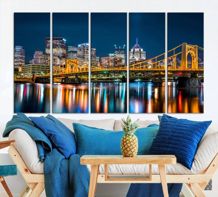 A cityscape at night showcases the illuminated beauty of Pittsburgh, with its bridge and skyscrapers casting glowing reflections on the river, all beautifully captured on this museum-quality canvas titled "Beautiful Pittsburgh Skyline Wall Art.