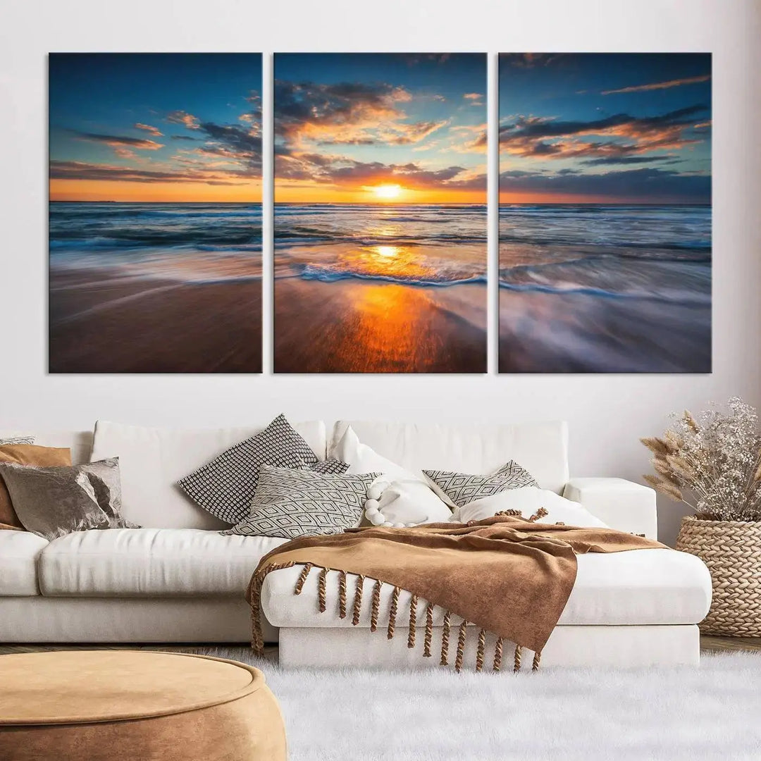 The living room showcases a triptych of the "Beautiful Sunset over the Horizon Beach" canvas wall art, crafted on museum-quality canvas with hand-assembled framing.