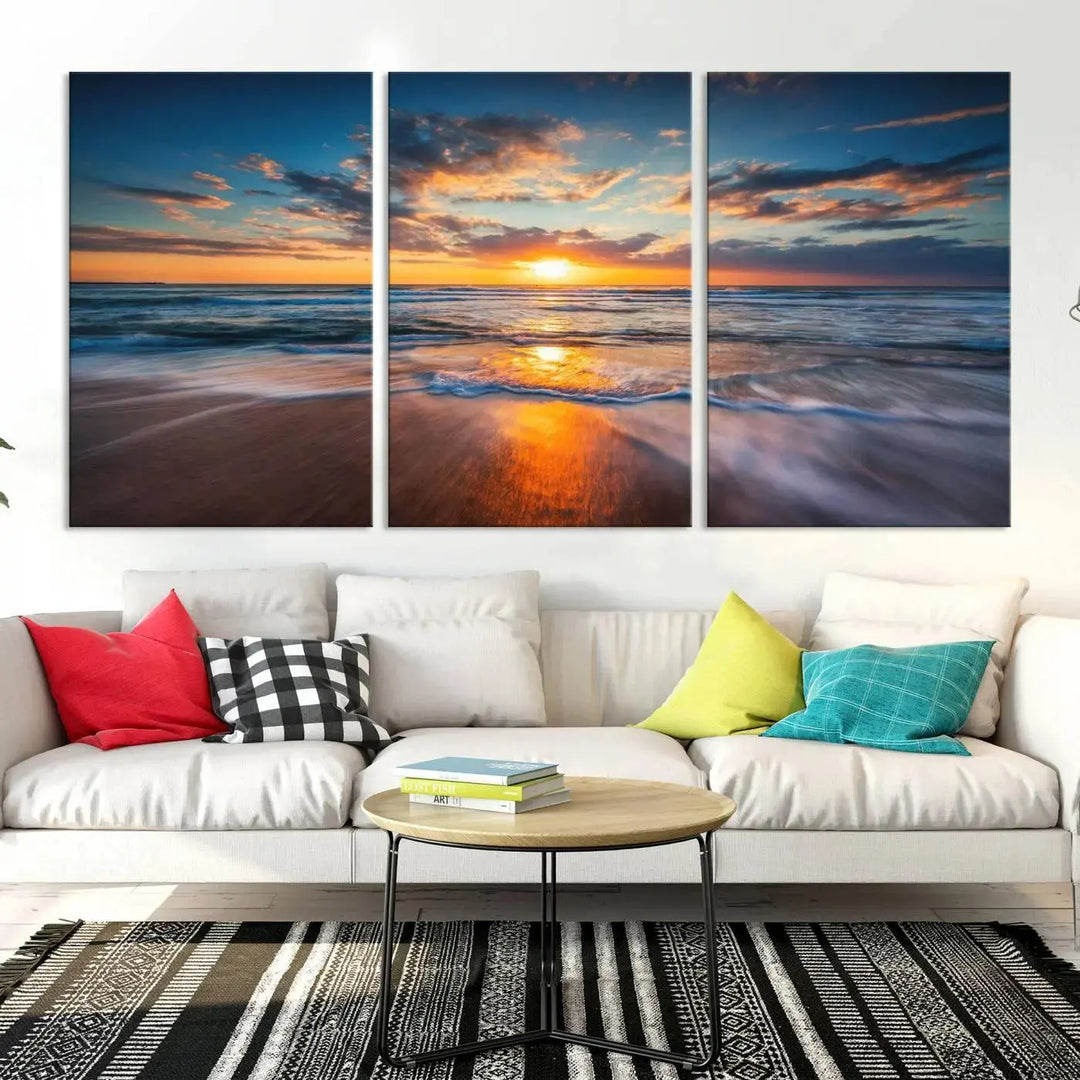 The living room showcases a triptych of the "Beautiful Sunset over the Horizon Beach" canvas wall art, crafted on museum-quality canvas with hand-assembled framing.