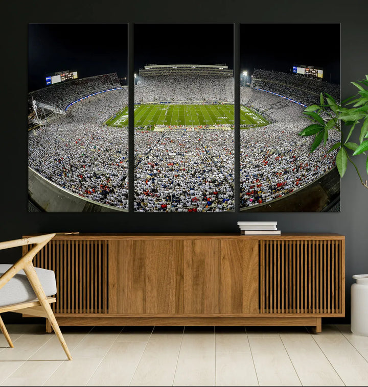 The Beaver Stadium Night Game Triple Canvas Wall Art - Penn State Nittany Lions Football Match features a panoramic view of a packed Beaver Stadium at night.