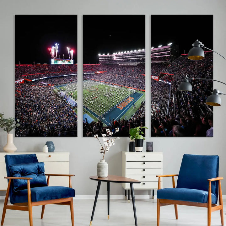 The Ben Hill Griffin Stadium Night Game Triple Canvas Wall Art - Florida Gators Football Match beautifully embodies the essence of a night game at the stadium, featuring fans, fireworks, and a marching band. This artwork is an ideal addition to a modern living room for any Florida Gators fan.